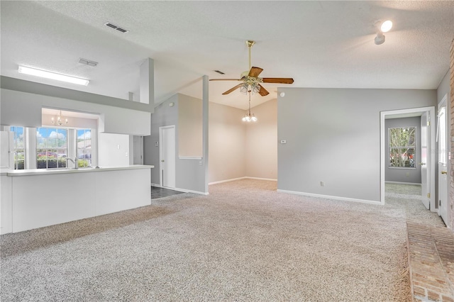 2212 Cortez Ct, Middleburg, FL 32068 - unfurnished living room featuring a chandelier, lofted ceiling, carpet floors, healthy amount of natural light, and a textured ceiling
