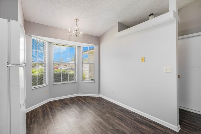2212 Cortez Ct, Middleburg, FL 32068 - spare room featuring wood finished floors, a chandelier, baseboards, and a textured ceiling
