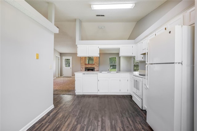 2212 Cortez Ct, Middleburg, FL 32068 - kitchen with white appliances, white cabinetry, dark wood finished floors, healthy amount of natural light, and lofted ceiling