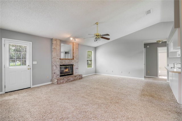 2212 Cortez Ct, Middleburg, FL 32068 - unfurnished living room with healthy amount of natural light, a ceiling fan, carpet flooring, a sink, and a textured ceiling