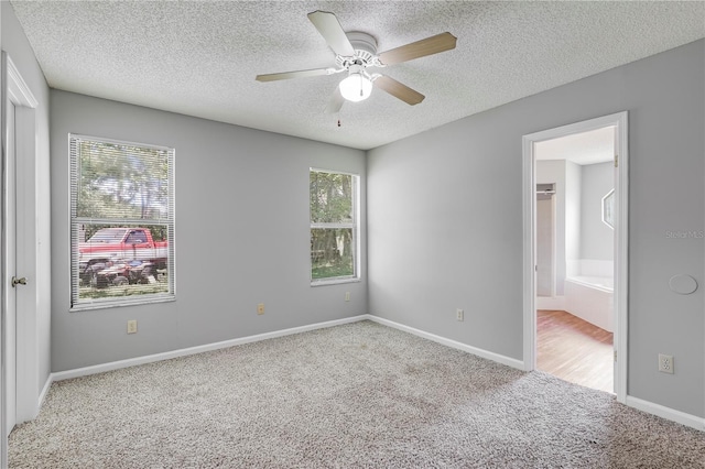 2212 Cortez Ct, Middleburg, FL 32068 - unfurnished bedroom featuring carpet floors, a textured ceiling, connected bathroom, a ceiling fan, and baseboards