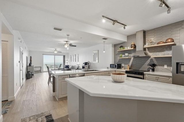 80 Surfview Dr Unit 511, Palm Coast, FL 32137 - kitchen with wall chimney exhaust hood, a sink, track lighting, a peninsula, and open shelves