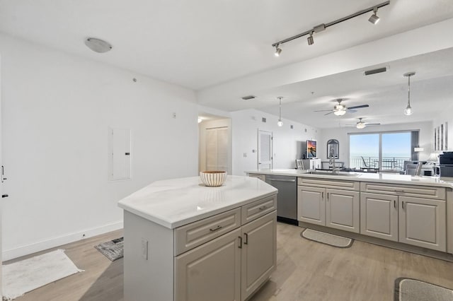 80 Surfview Dr Unit 511, Palm Coast, FL 32137 - kitchen featuring dishwasher, open floor plan, a center island, light wood-style floors, and a sink