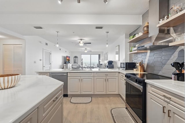 80 Surfview Dr Unit 511, Palm Coast, FL 32137 - kitchen featuring stainless steel appliances, open shelves, light wood finished floors, wall chimney exhaust hood, and light countertops