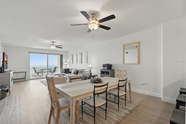 80 Surfview Dr Unit 511, Palm Coast, FL 32137 - dining room featuring a ceiling fan, wood finished floors, and baseboards