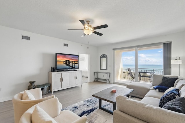 80 Surfview Dr Unit 511, Palm Coast, FL 32137 - living area featuring light wood-style floors, ceiling fan, and baseboards