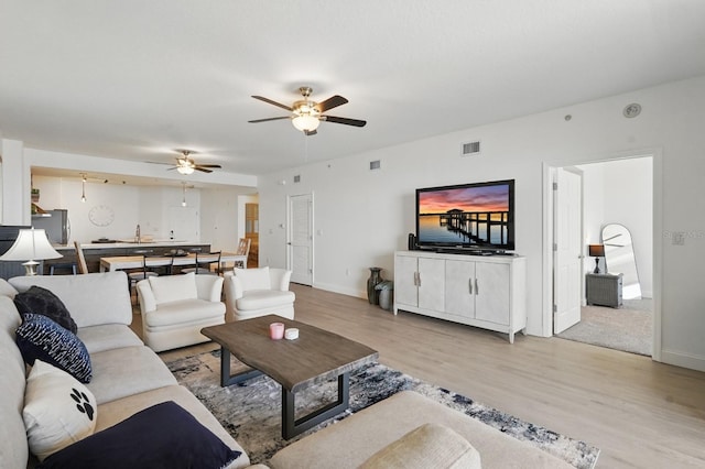 80 Surfview Dr Unit 511, Palm Coast, FL 32137 - living room featuring light wood-type flooring, a ceiling fan, and baseboards