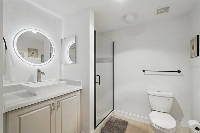 80 Surfview Dr Unit 511, Palm Coast, FL 32137 - full bathroom with toilet, a shower stall, wood finished floors, and vanity