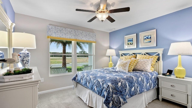 151 Greenwood Dr, Palm Coast, FL 32137 - bedroom featuring light colored carpet, baseboards, and ceiling fan