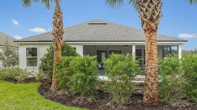 151 Greenwood Dr, Palm Coast, FL 32137 - rear view of house featuring a shingled roof, a sunroom, ceiling fan, and stucco siding