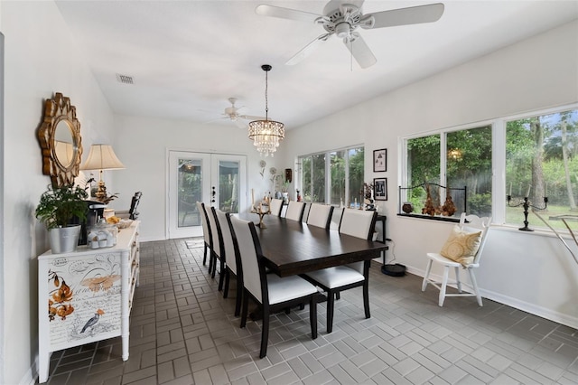 135 Lambert Ave, Flagler Beach, FL 32136 - dining room with ceiling fan, french doors, a chandelier, and baseboards