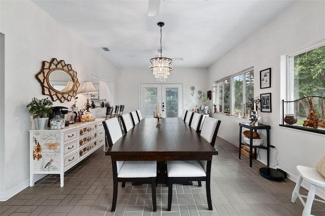 135 Lambert Ave, Flagler Beach, FL 32136 - dining room featuring a chandelier, healthy amount of natural light, french doors, and baseboards
