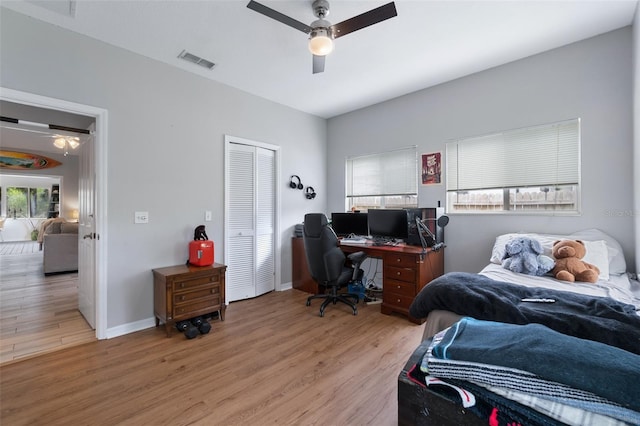 135 Lambert Ave, Flagler Beach, FL 32136 - bedroom with multiple windows, light wood-type flooring, a desk, and a closet