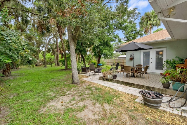 135 Lambert Ave, Flagler Beach, FL 32136 - view of green lawn featuring french doors, a wooden deck, and outdoor dining area