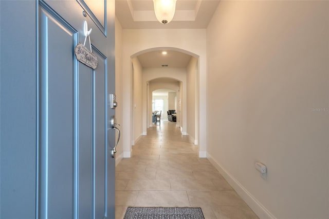 2840 Monaghan Dr, Ormond Beach, FL 32174 - entryway featuring arched walkways, light tile patterned floors, and baseboards