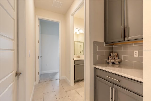2840 Monaghan Dr, Ormond Beach, FL 32174 - full bath featuring backsplash, tile patterned flooring, vanity, baseboards, and a shower