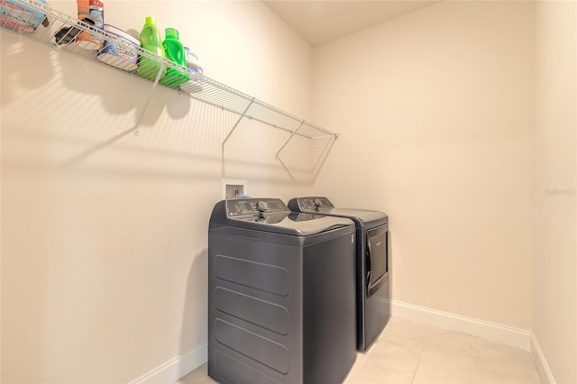2840 Monaghan Dr, Ormond Beach, FL 32174 - laundry room with separate washer and dryer, baseboards, and light tile patterned floors