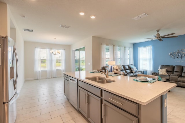 2840 Monaghan Dr, Ormond Beach, FL 32174 - kitchen with appliances with stainless steel finishes, a sink, open floor plan, gray cabinets, and a chandelier