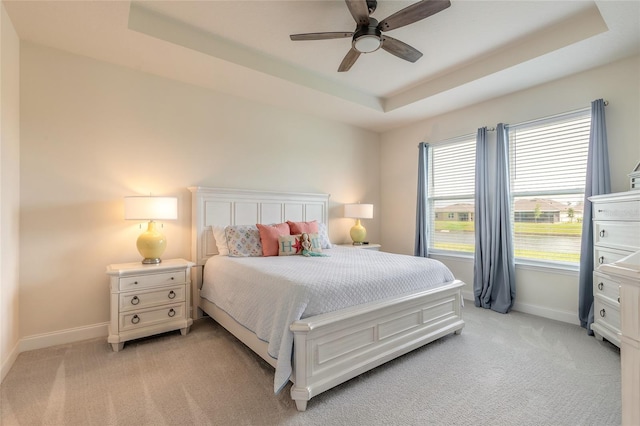 2840 Monaghan Dr, Ormond Beach, FL 32174 - bedroom featuring baseboards, light colored carpet, and a raised ceiling