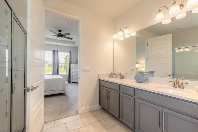 2840 Monaghan Dr, Ormond Beach, FL 32174 - ensuite bathroom featuring tile patterned floors, a tile shower, double vanity, ceiling fan, and baseboards