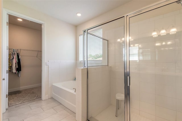 2840 Monaghan Dr, Ormond Beach, FL 32174 - full bathroom with a garden tub, a stall shower, tile patterned flooring, a walk in closet, and recessed lighting