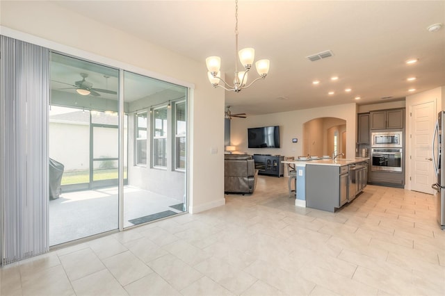 2840 Monaghan Dr, Ormond Beach, FL 32174 - kitchen featuring stainless steel appliances, open floor plan, ceiling fan, arched walkways, and recessed lighting