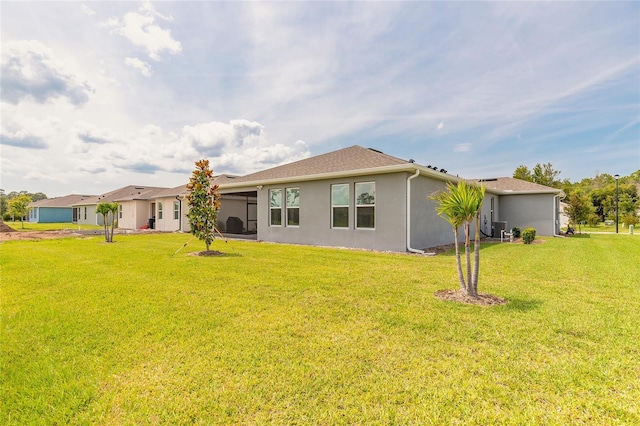 2840 Monaghan Dr, Ormond Beach, FL 32174 - rear view of property with stucco siding and a lawn
