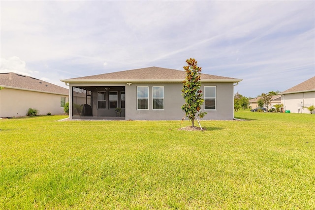 2840 Monaghan Dr, Ormond Beach, FL 32174 - rear view of house with a sunroom, a yard, and stucco siding