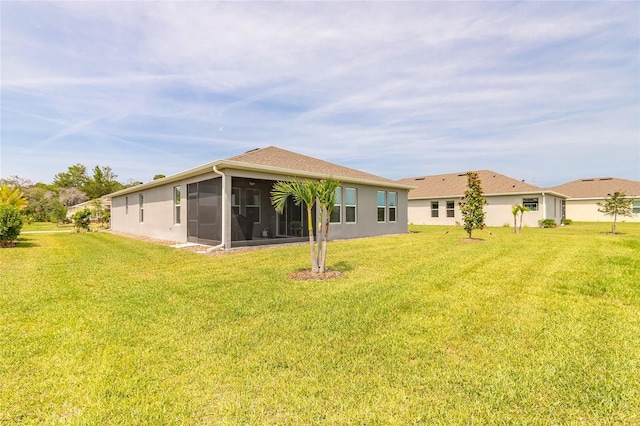 2840 Monaghan Dr, Ormond Beach, FL 32174 - rear view of house featuring a sunroom, a yard, and stucco siding