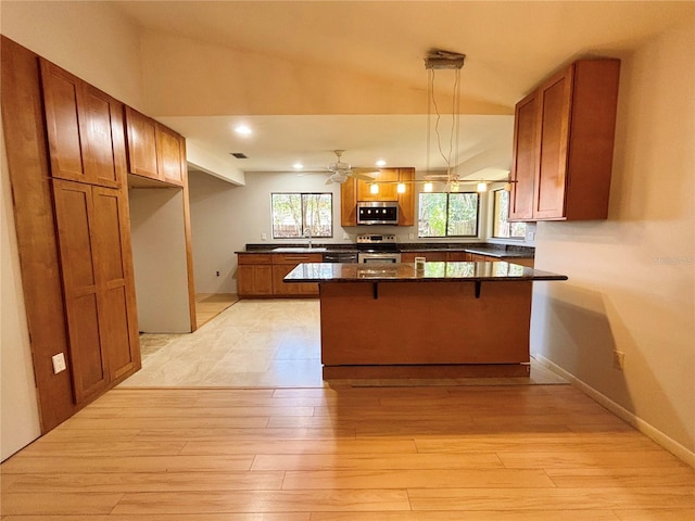 20 Blakeshire Pl, Palm Coast, FL 32137 - kitchen with stainless steel appliances, a sink, light wood-type flooring, a breakfast bar, and brown cabinetry