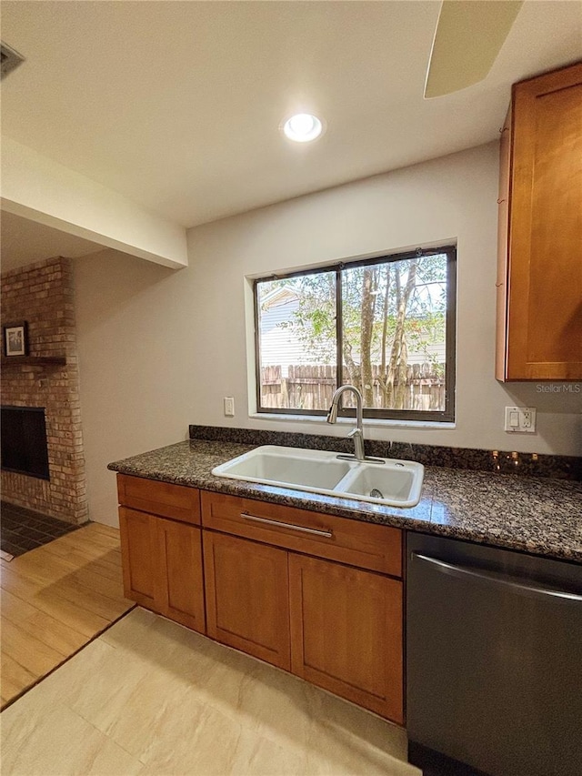 20 Blakeshire Pl, Palm Coast, FL 32137 - kitchen with dishwasher, a sink, brown cabinetry, a fireplace, and recessed lighting