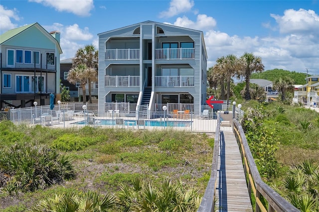 2900 Coastal Hwy Unit 1, Saint Augustine, FL 32084 - rear view of house with fence, a patio area, and a balcony