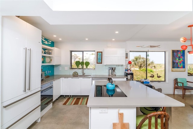 2900 Coastal Hwy Unit 1, Saint Augustine, FL 32084 - kitchen featuring concrete floors, white fridge, open shelves, oven, and recessed lighting