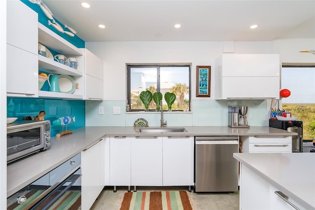 2900 Coastal Hwy Unit 1, Saint Augustine, FL 32084 - kitchen featuring appliances with stainless steel finishes, white cabinets, a sink, light countertops, and modern cabinets