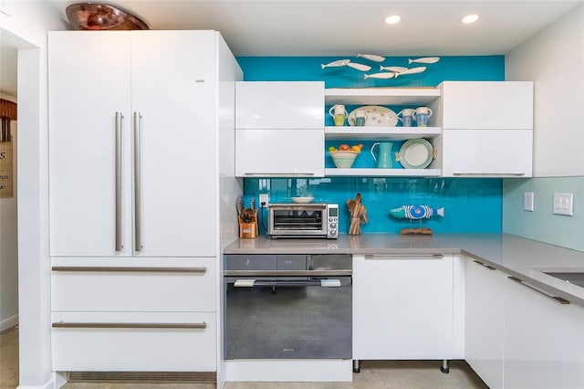 2900 Coastal Hwy Unit 1, Saint Augustine, FL 32084 - kitchen featuring high end fridge, white cabinetry, modern cabinets, light countertops, and recessed lighting