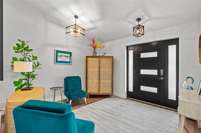 54 Fordham Ln, Palm Coast, FL 32137 - entryway featuring a chandelier, lofted ceiling, wood finished floors, and baseboards