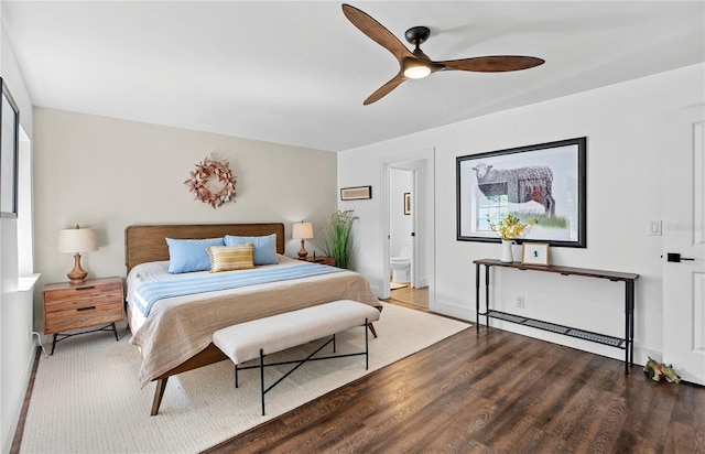 54 Fordham Ln, Palm Coast, FL 32137 - bedroom featuring wood finished floors, baseboards, a ceiling fan, and ensuite bath