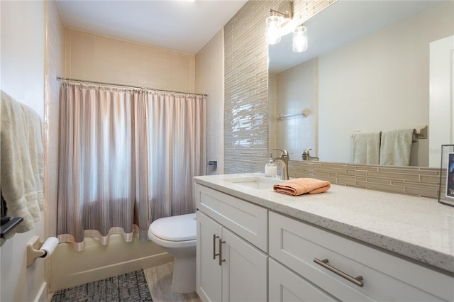 54 Fordham Ln, Palm Coast, FL 32137 - bathroom featuring vanity, toilet, shower / bathtub combination with curtain, tasteful backsplash, and wood finished floors