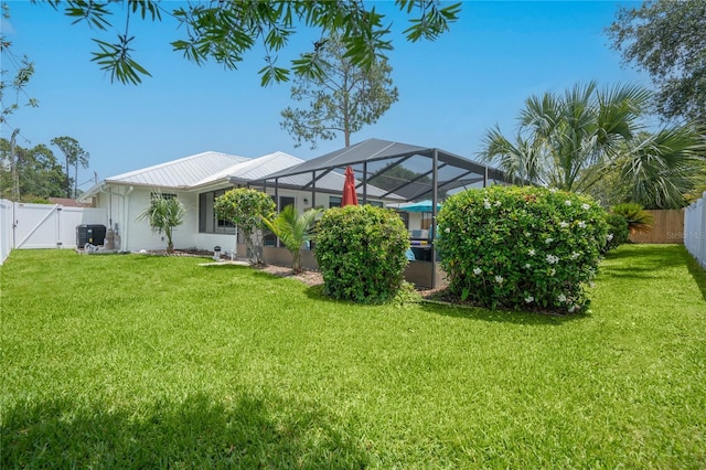 54 Fordham Ln, Palm Coast, FL 32137 - back of house with a gate, glass enclosure, and metal roof