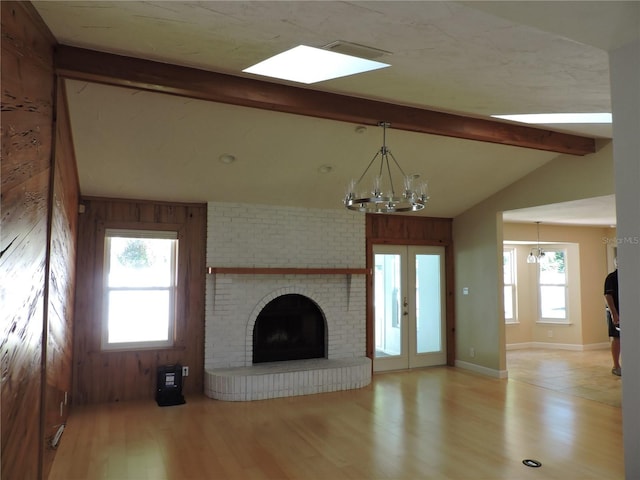 543 Sandy Oaks Blvd, Ormond Beach, FL 32174 - unfurnished living room featuring a chandelier, light wood-style floors, and a fireplace