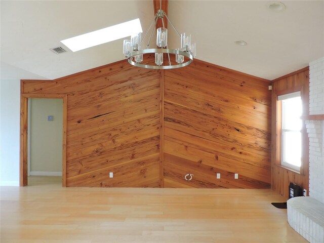 543 Sandy Oaks Blvd, Ormond Beach, FL 32174 - unfurnished dining area with a chandelier, wood finished floors, wood walls, and a skylight