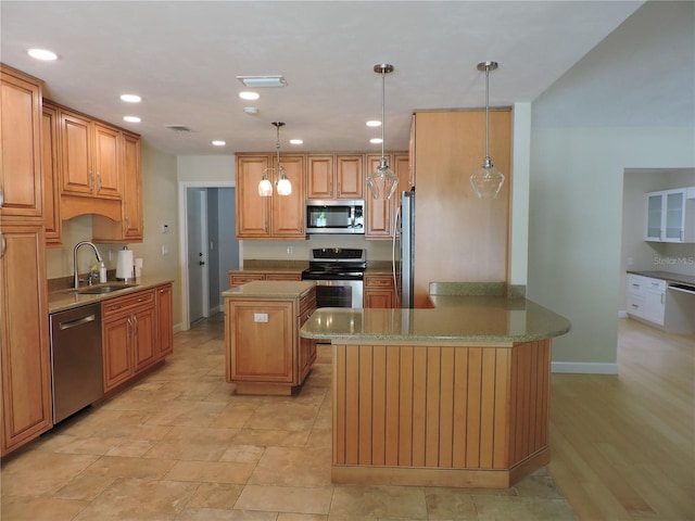 543 Sandy Oaks Blvd, Ormond Beach, FL 32174 - kitchen with stainless steel appliances, a sink, a peninsula, a kitchen island, and hanging light fixtures