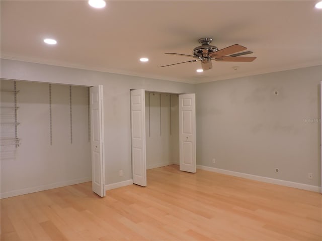 543 Sandy Oaks Blvd, Ormond Beach, FL 32174 - unfurnished bedroom featuring multiple closets, light wood-style floors, recessed lighting, crown molding, and baseboards