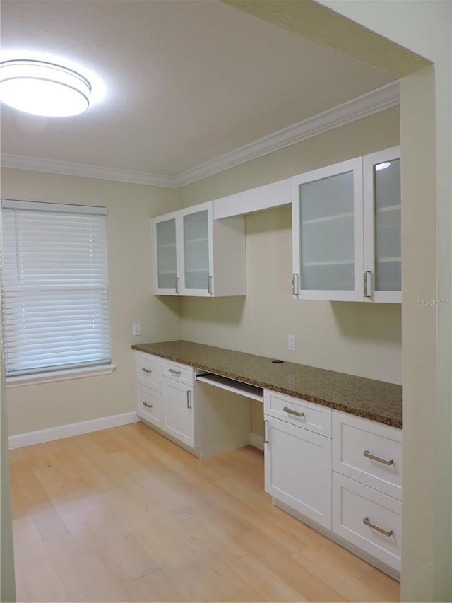 543 Sandy Oaks Blvd, Ormond Beach, FL 32174 - kitchen featuring light wood-style flooring, ornamental molding, white cabinetry, glass insert cabinets, and built in study area
