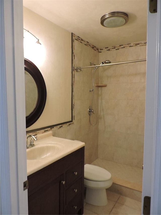 543 Sandy Oaks Blvd, Ormond Beach, FL 32174 - bathroom featuring vanity, a tile shower, toilet, and tile patterned flooring