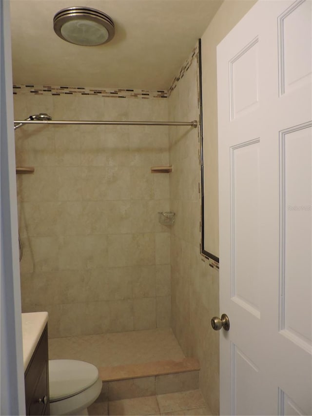 543 Sandy Oaks Blvd, Ormond Beach, FL 32174 - bathroom with vanity, a tile shower, toilet, and tile patterned flooring