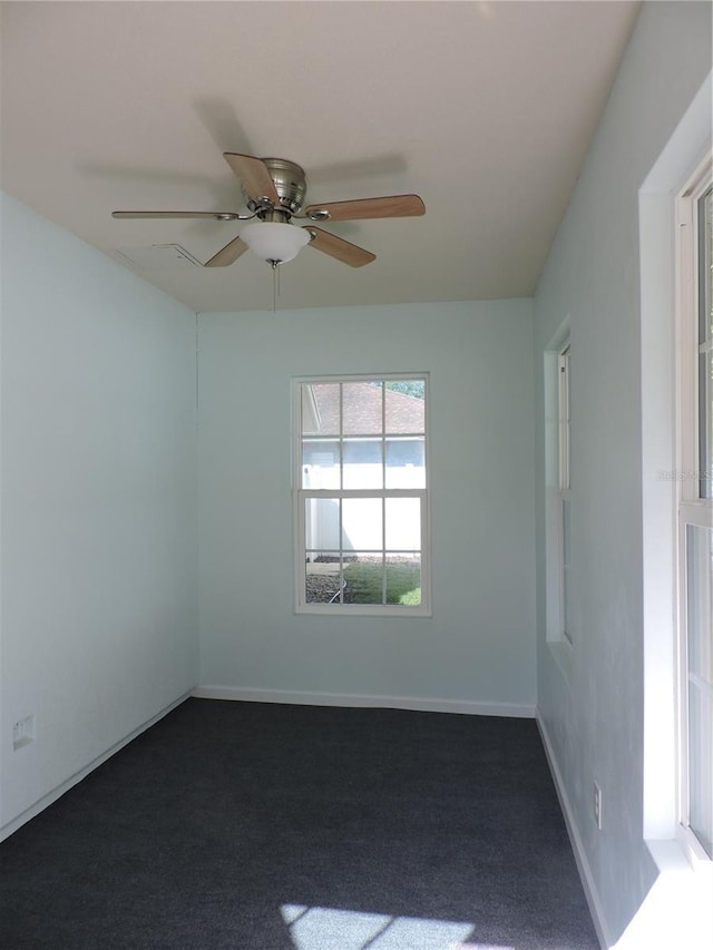 543 Sandy Oaks Blvd, Ormond Beach, FL 32174 - empty room with ceiling fan, dark colored carpet, and baseboards