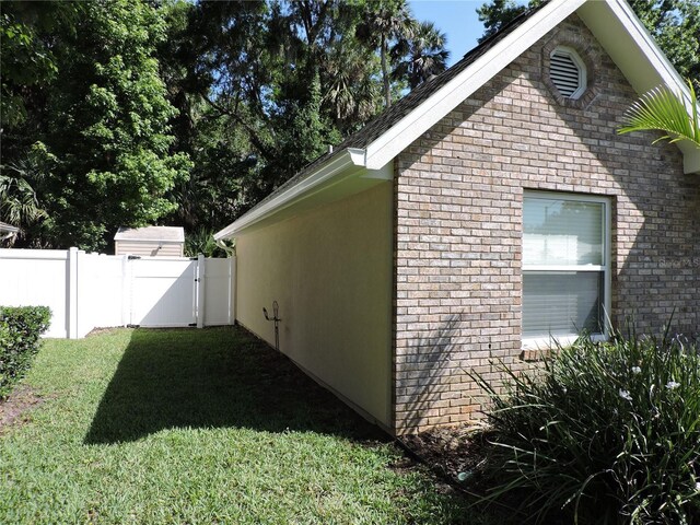 543 Sandy Oaks Blvd, Ormond Beach, FL 32174 - view of side of home with brick siding and a gate