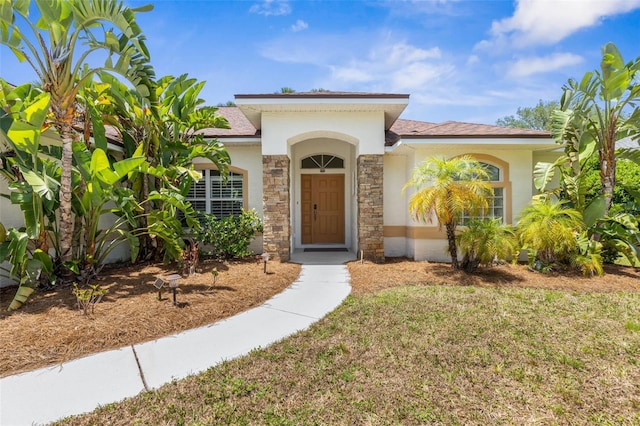 11 White Oak Ln, Palm Coast, FL 32164 - view of front of property with stone siding, stucco siding, and a front lawn