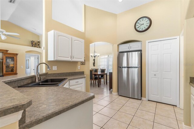 11 White Oak Ln, Palm Coast, FL 32164 - kitchen featuring freestanding refrigerator, arched walkways, a sink, ceiling fan, and high vaulted ceiling